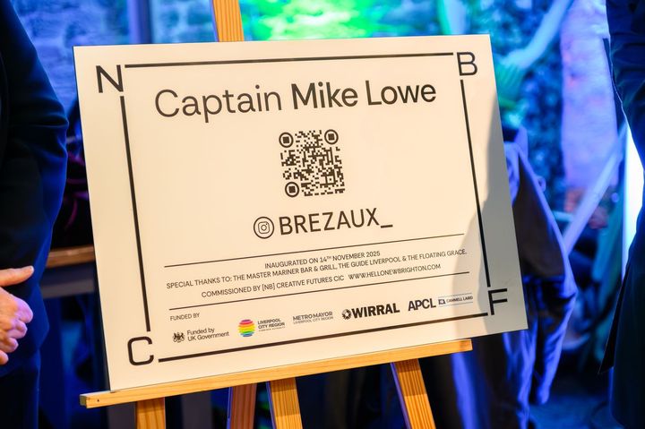 The Captain Mike Lowe plaque with its QR code on an easel.